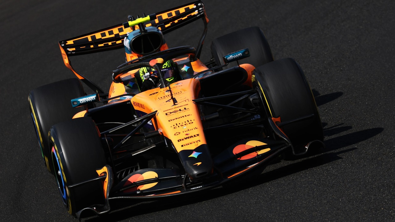 A McLaren Formula 1 car runs on a dry circuit