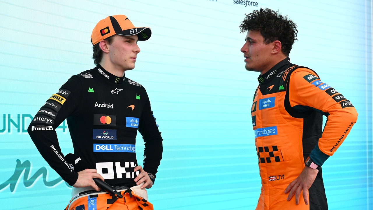 McLaren Formula 1 team-mates stand together in the paddock